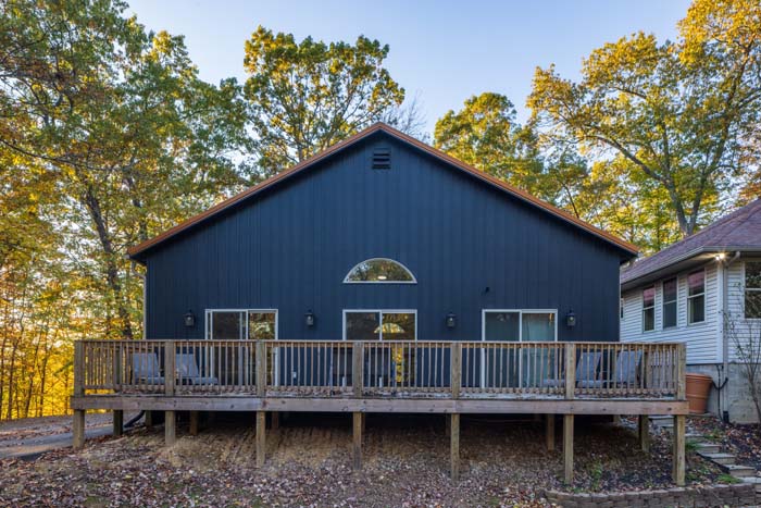 Rear gable of Peach Tree Lodge with arched window and long deck