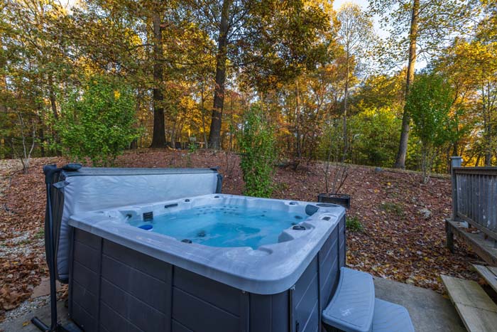 Hot tub overlooking the autumn forest at Peach Tree Lodge