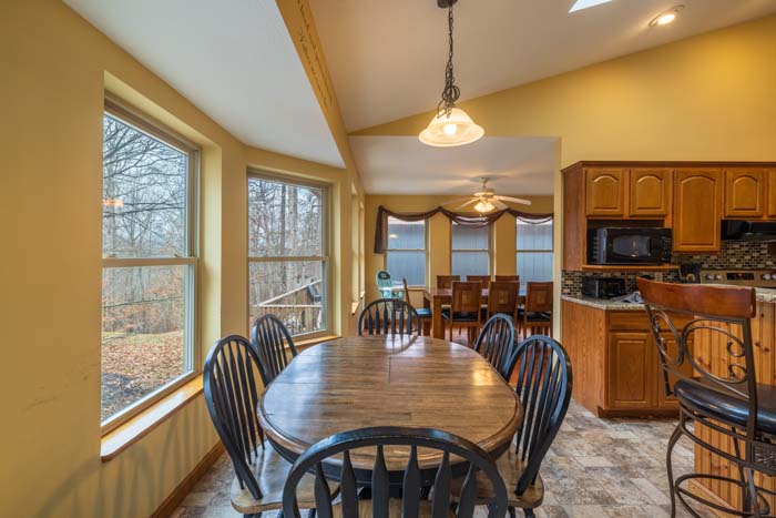 Dining table beside the kitchen with bay window at Peach Tree Lodge