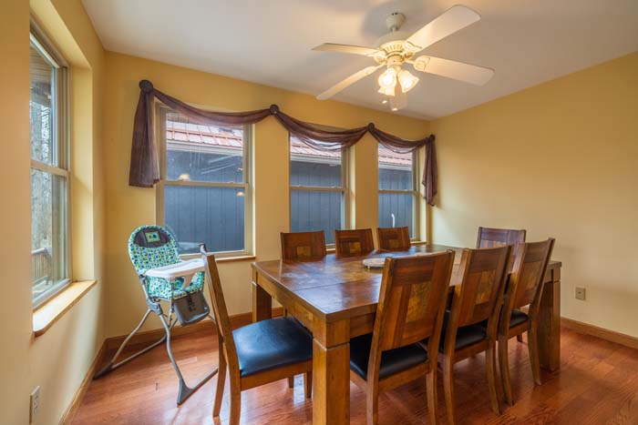 Dining room seating for eight with bay windows