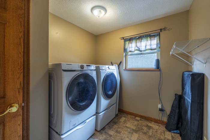 Laundry room with full-size front-load washer and dryer