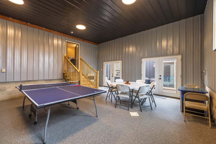 Game room with ping-pong and seating near the stairs