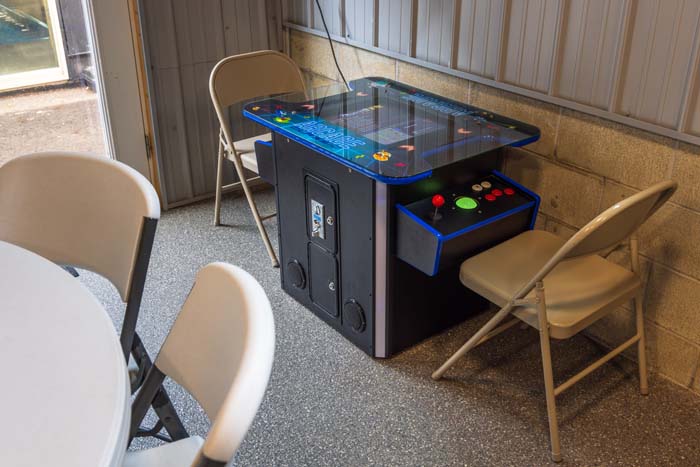 Arcade cocktail game table with seating at Peach Tree Lodge