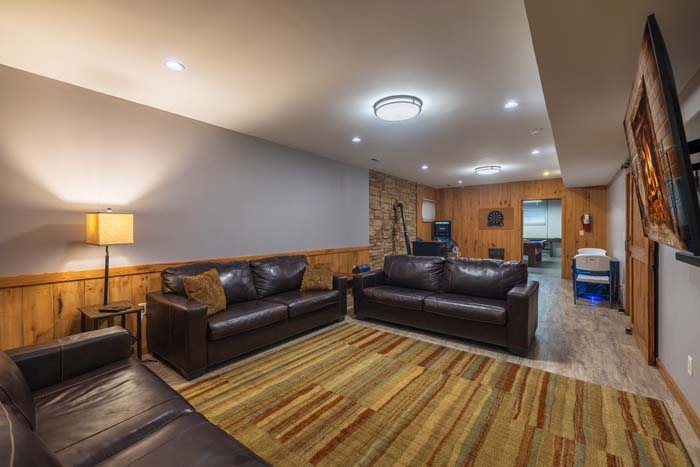Lower-level living room with leather sofas