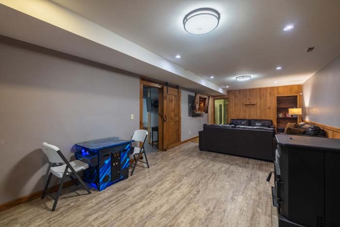 Rec room with luxury vinyl flooring and barn door