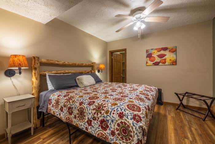 Bedroom with king log bed and floral bedding