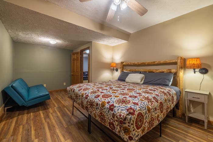 Bedroom with king bed, floral bedding, and seating