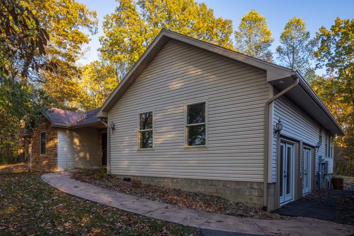 Side exterior of Peach Tree Lodge with walkway and attached garage