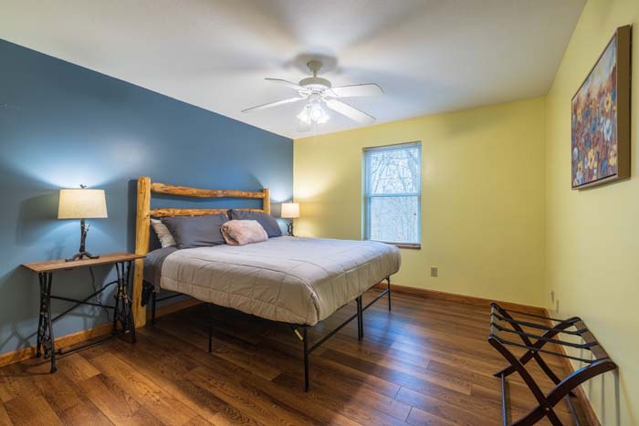 Bedroom with log bed and blue accent wall