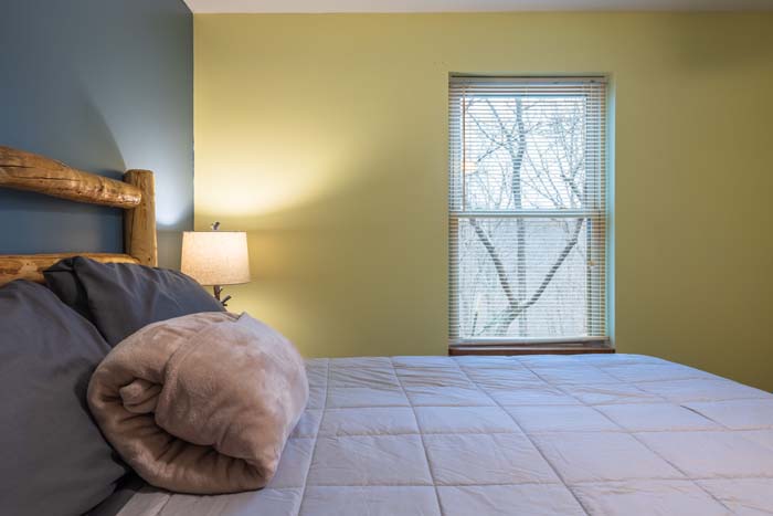 Bedroom corner with log bed and window
