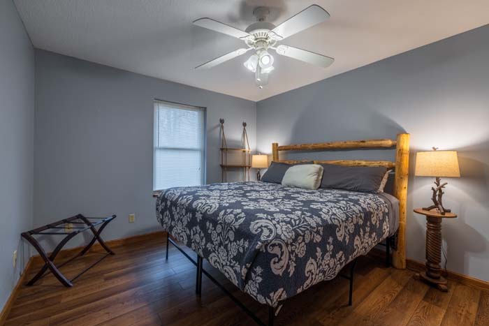 King bedroom with floral bedding and blue walls