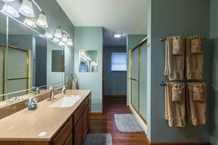 Double-vanity bathroom with framed glass shower