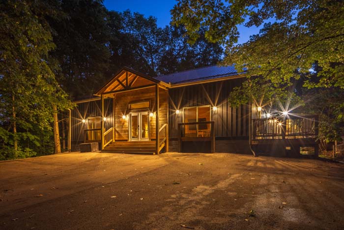 Peach Tree Lodge exterior illuminated at dusk