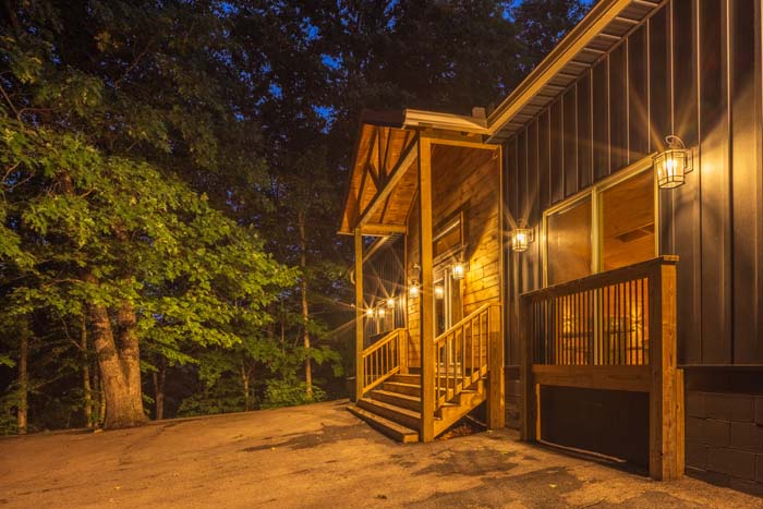 Lit side entry porch at dusk at Peach Tree Lodge