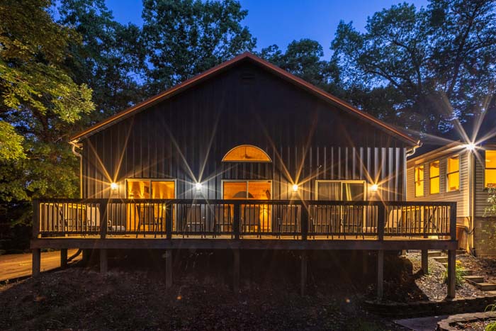 Rear deck of Peach Tree Lodge lit at twilight