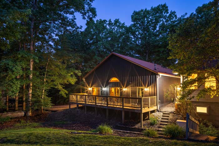 Rear deck and woods at twilight at Peach Tree Lodge