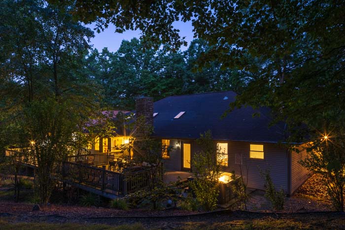 Peach Tree Lodge lit among the trees at dusk