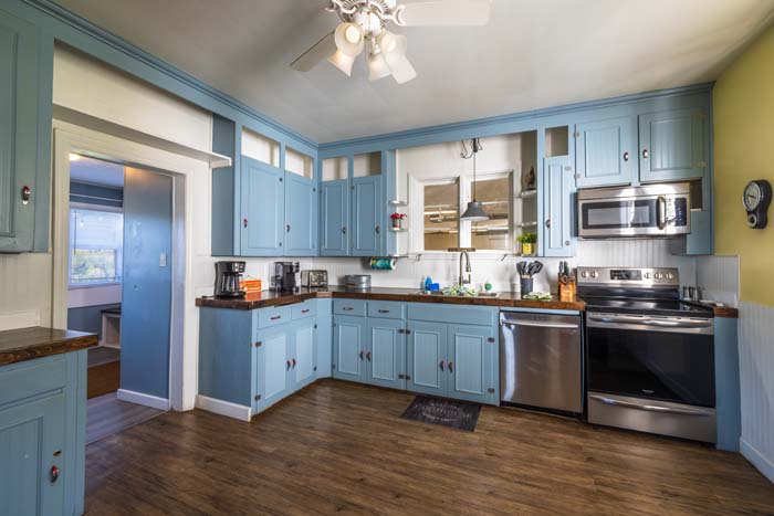 Farmhouse kitchen with blue cabinets and stainless appliances