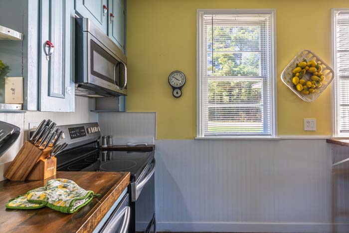 Kitchen with electric range and butcher-block counters