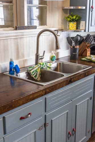 Kitchen double sink with butcher-block counter and window