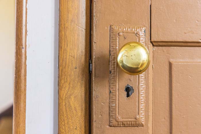 Antique brass doorknob on a wood door