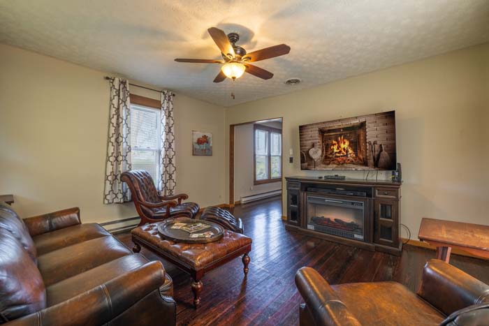 Living room with leather seating and electric fireplace
