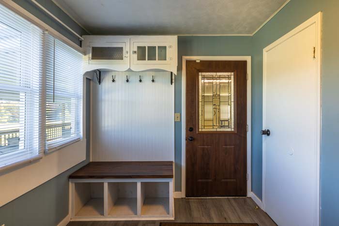 Mudroom entry with bench and coat hooks at Ruby's Farmhouse