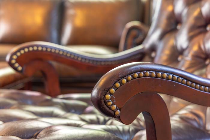 Tufted leather chair with nailhead trim detail