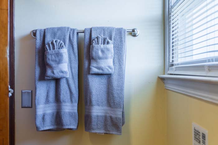 Fresh towels on the rail by a window