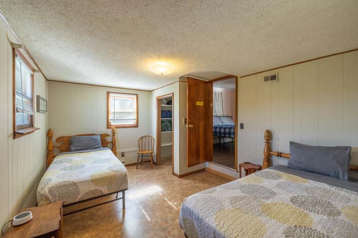 Twin bedroom with two beds and floral quilts