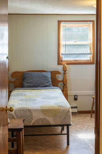 Bedroom with patterned quilt and window