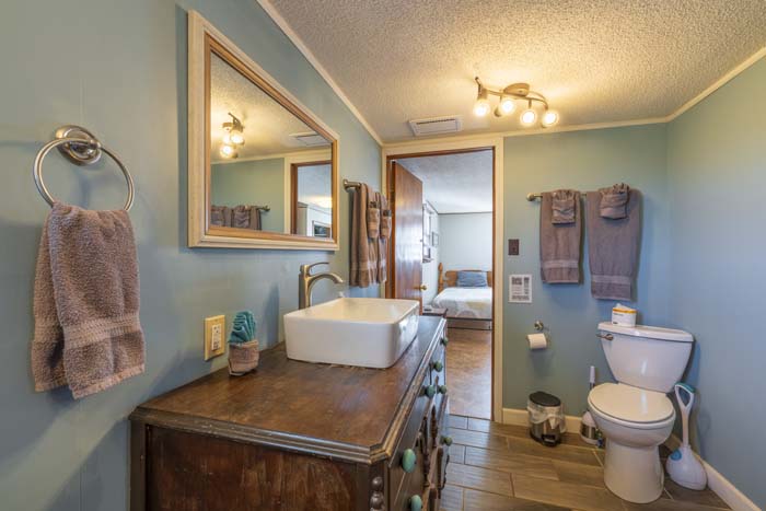 Bathroom with vessel-sink vanity and mirror