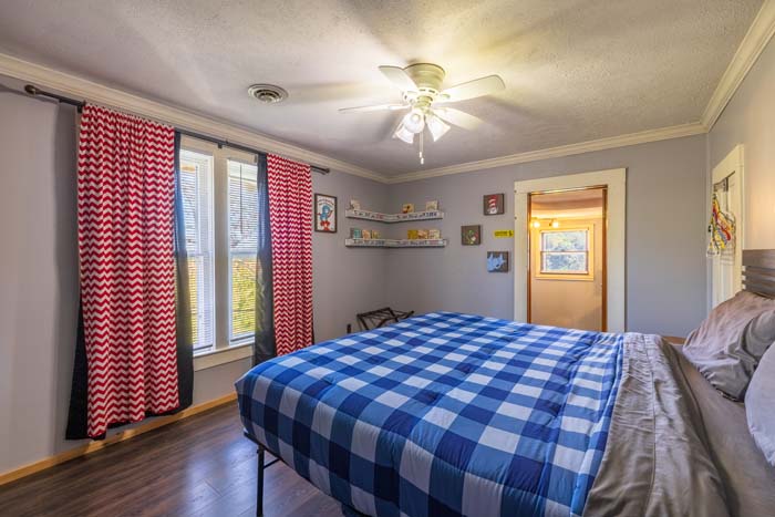 Kids' bedroom with chevron curtains and book ledges
