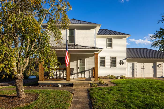 Front of Ruby's Farmhouse with porch and driveway