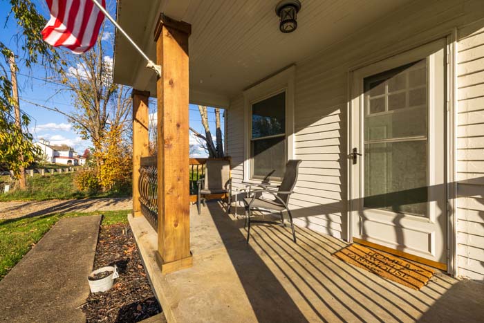Covered porch with American flag at Ruby's Farmhouse