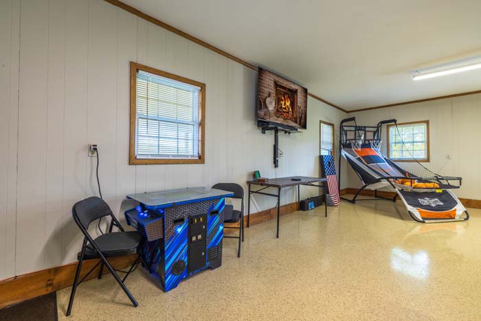 Game room with basketball arcade game and seating