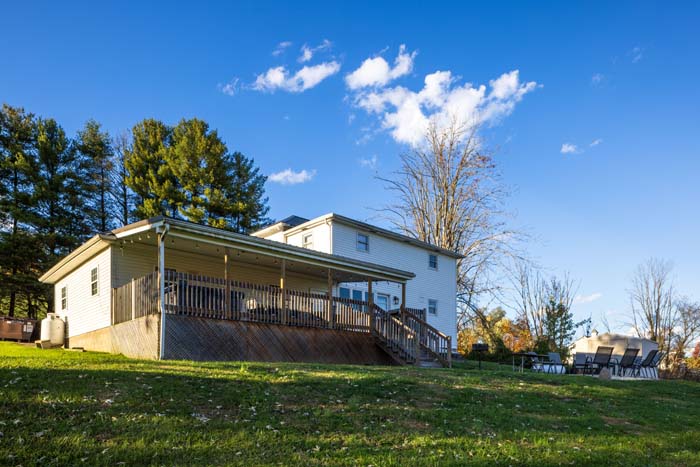 Rear exterior with covered deck at Ruby's Farmhouse