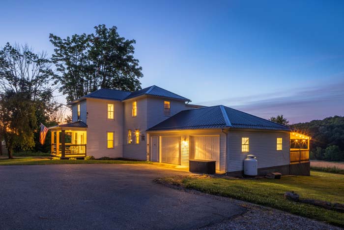 Ruby's Farmhouse illuminated at dusk