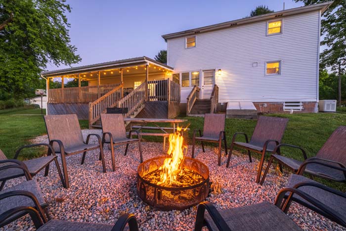 Fire pit at dusk with the farmhouse behind