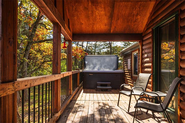 Private hot tub surrounded by woods at Sassafras Cabin