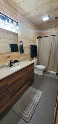 bathroom with double sink, shower and tub