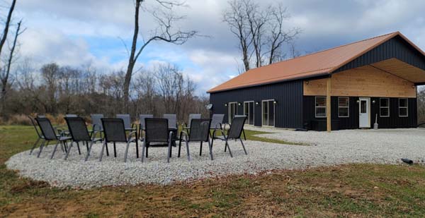 seating around firepit near black pool barn