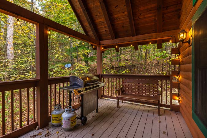Multiple decks overlooking woods at Catbird Cabin