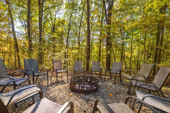 Lower deck overlooking wooded hillside at Catbird Cabin