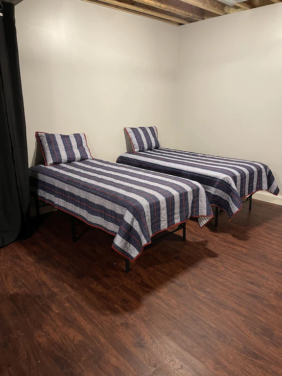 2 beds with stripped bedding