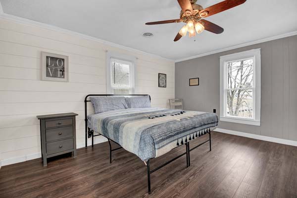 bedroom with ceiling fan and night stand