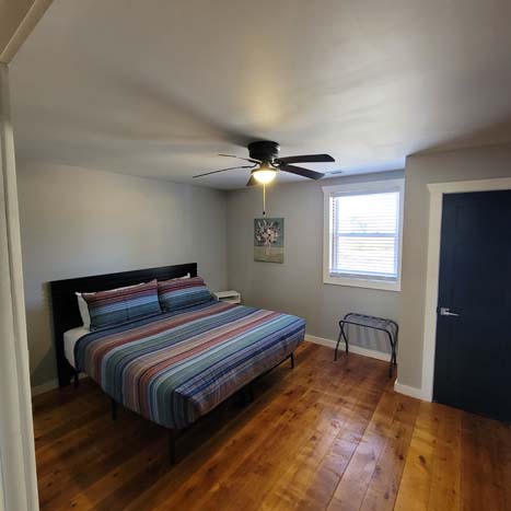 bedroom with ceiling fan and window
