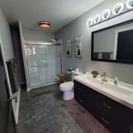 bathroom with large vanity, shower