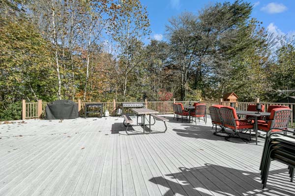 large deck with picnic table and grill