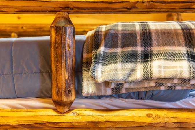 Log king bed in master bedroom at Little Pine Cabin